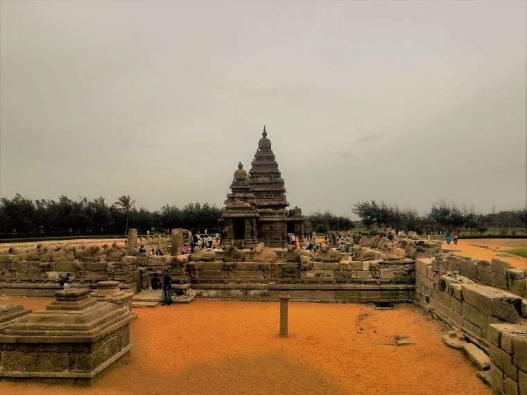 Shore Temple of Mahabalipuram -  a huge ancient Hindu Temple with intrivate carvings stand in the sea shore of Mahabalipuram with the overcast sky in the background