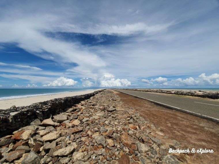 Clear blue sky with white clouds on the horizon as we drive through the Dhanushkodi Road flanks by the ocean on both sides.