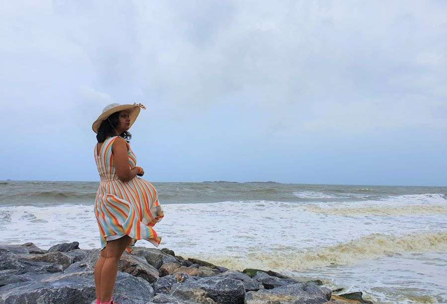 Me enjoying a moment of solitude at the rocks of Udupi beach on a cloudy day