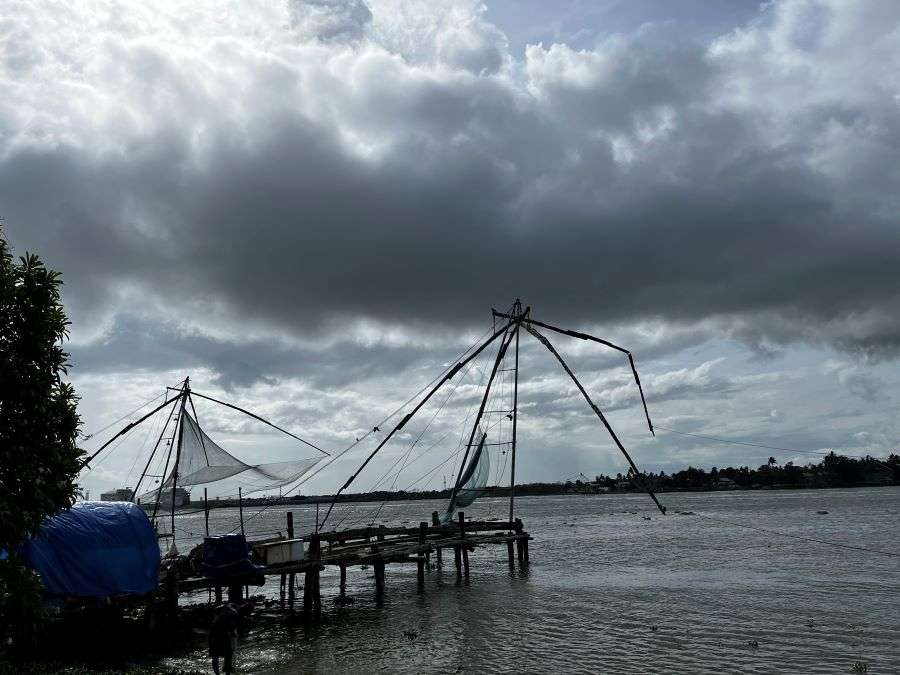 The iconic Chinese Fishing Nets in Kochi against the overcast sky 