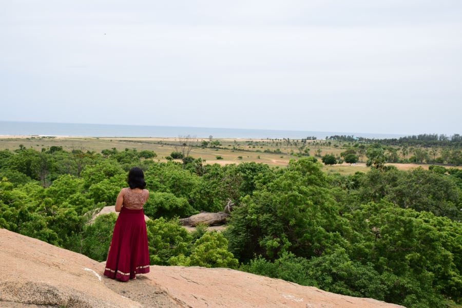 The Best 1-Day Mahabalipuram Itinerary And Travel Guide for 2024 1 That's me watching the panoramic views of Mahabalipuram from the cave temples.