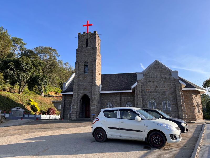 Cars parked infront of CSI church in Munnar