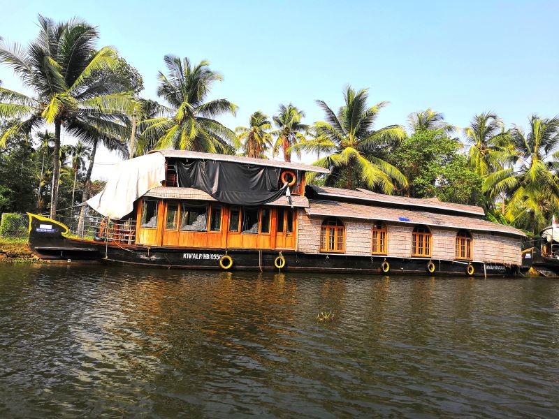 A large houseboat anchored at the lake in Alleppey. 