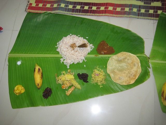 A vegetarian food palate called Kerala Sadya which has rice, pickle, papad, vegetables, banana, Kerala-special banana chips and red chutney