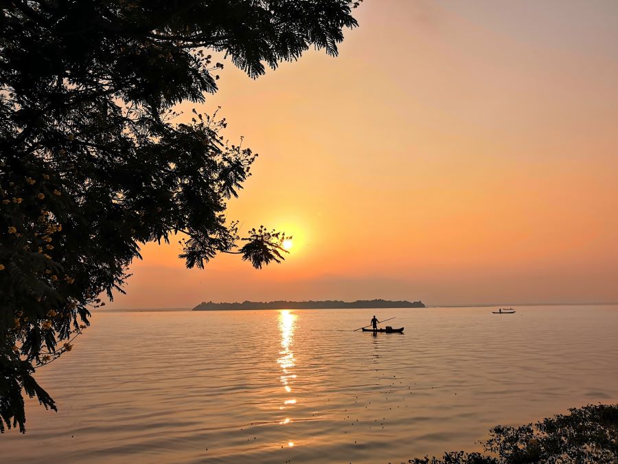 Sunrise at the Vembanad lake and a solitary boatman out fishing in the backwaters of alleppey. This is the highlight on one day Alleppey itinerary