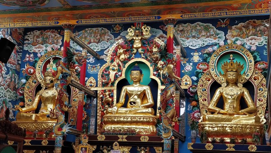 Glittering Golden statues of Buddha in the Namdroling Monastery of Bylakuppe