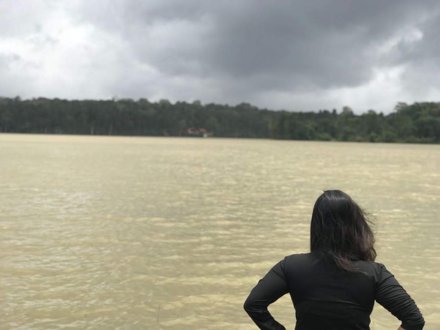 Girl at the Harangi dam watching the rising water levels against the clouded sky