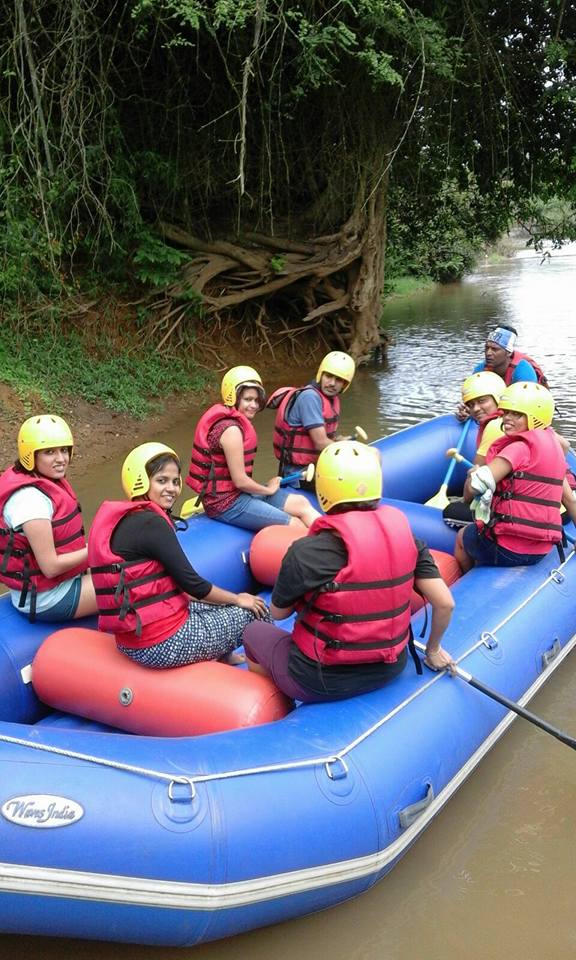 A group of five girls and two boys along with the trainer ready to go for the river rafting adventure in Coorg