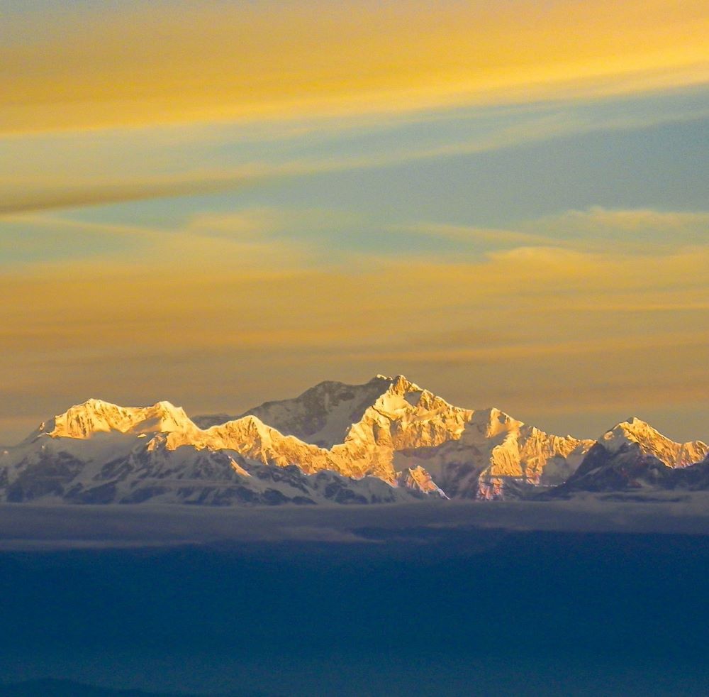 Top 17 Places with the Best Views of Kanchenjunga 3 Golden hue all over the sky with Kanchenjunga peaks shining bright and clear as seen from Tiger Hill vantage point in Darjeeling